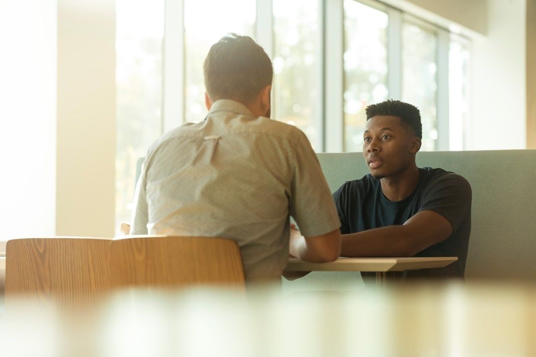 Two people discussing an apprenticeship situation at a table