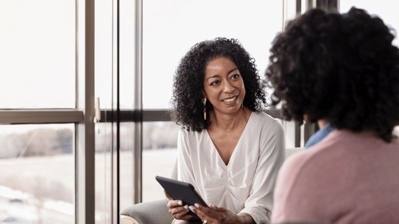 Career counselor speaking with two adults during a consultation